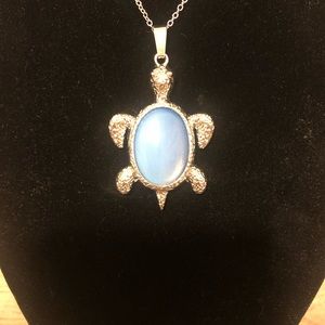 Fashion necklace with a clear quartz turtle pendant.